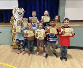 Top Tiger students pictured with school mascot.
